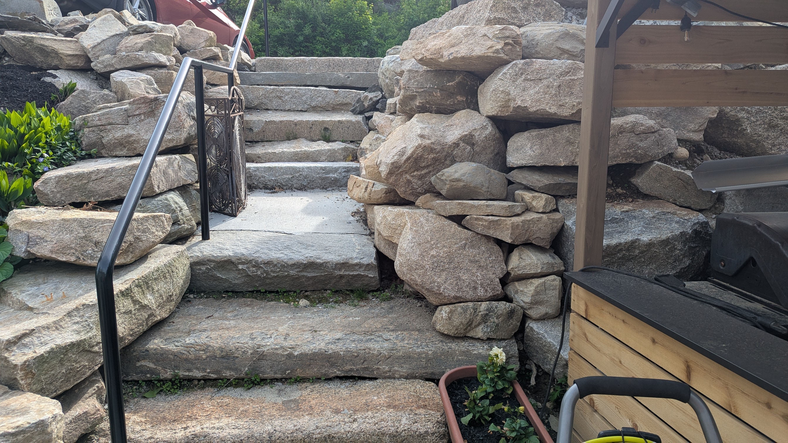 Custom boulder stone steps with metal handrail