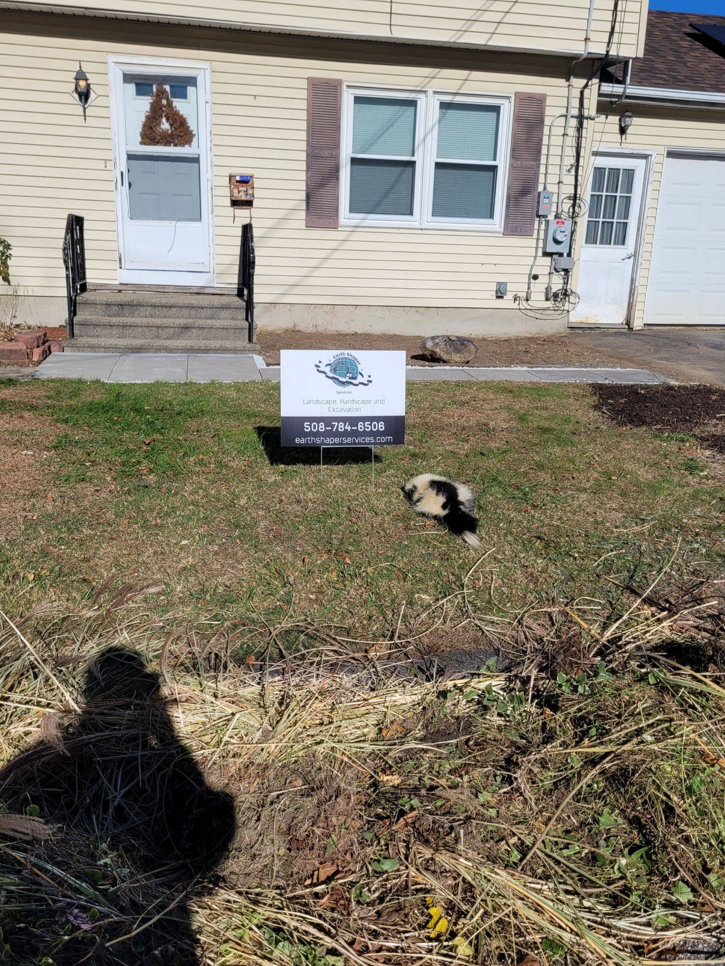 Before state of residential landscaping project with Earth Shaper sign