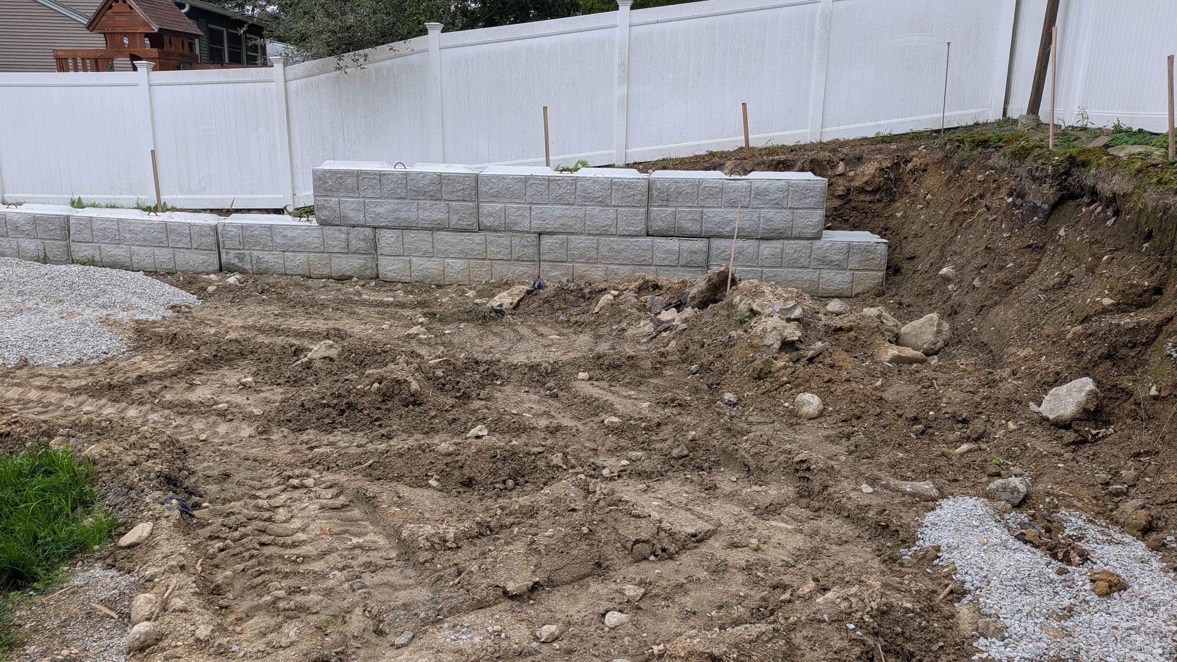 Completed stepped concrete block retaining wall built by Earth Shaper Services